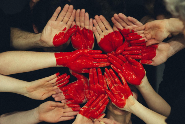 hands painted red in shape of heart to depict company culture