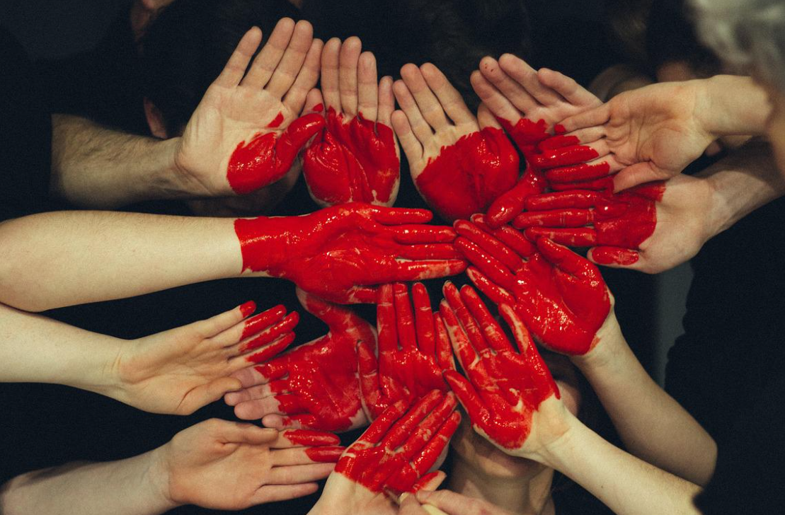 hands painted red in shape of heart to depict company culture