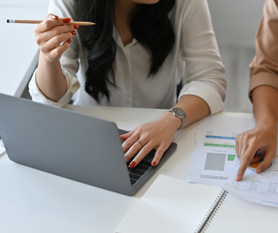 two women working at laptop
